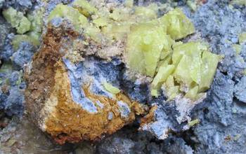 Nodule of Oregon blue clay, coated with red clay and sulfur crystals encased in white clay.